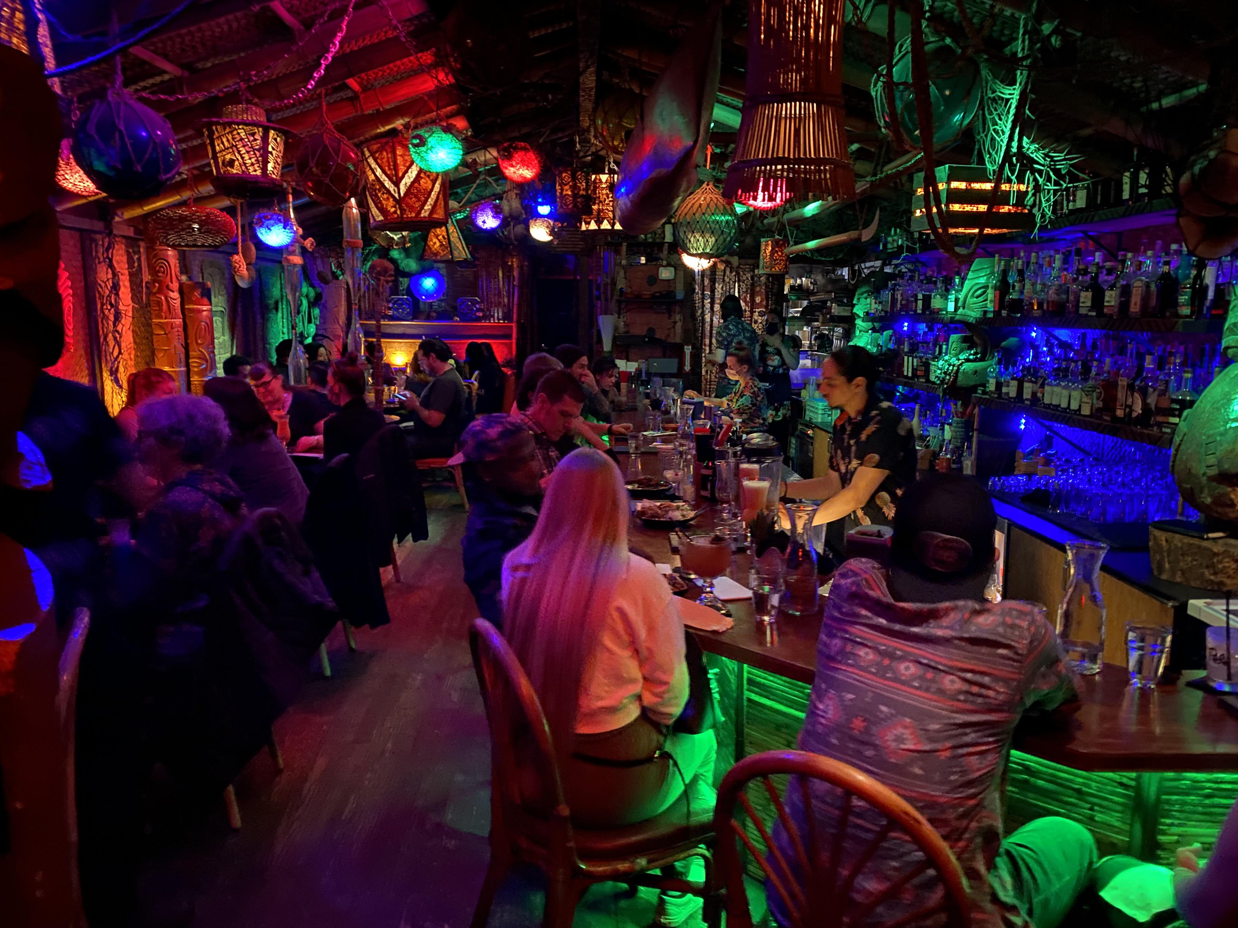 Inside Hale Pele—carved tikis and tropical lighting
