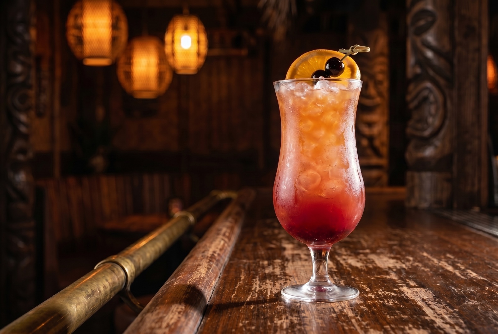 A Hurricane—dark rum, passion fruit, lime, and grenadine in a tall curved hurricane glass